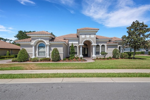 6527 Eagle Ridge Way, Lakeland, FL 33813 - view of front of house featuring a front lawn, a tiled roof, and stucco siding