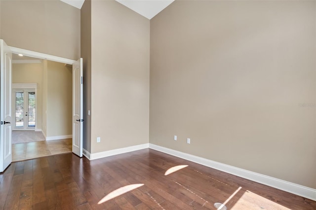 6527 Eagle Ridge Way, Lakeland, FL 33813 - unfurnished room featuring dark wood-type flooring, french doors, and high vaulted ceiling