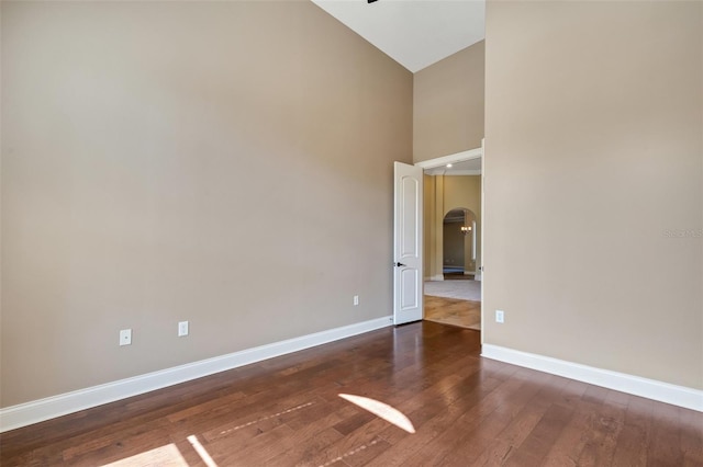6527 Eagle Ridge Way, Lakeland, FL 33813 - unfurnished room featuring arched walkways, hardwood / wood-style flooring, and high vaulted ceiling