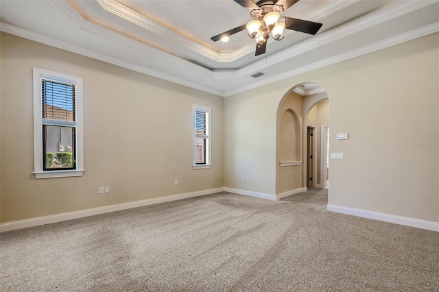 6527 Eagle Ridge Way, Lakeland, FL 33813 - spare room with a raised ceiling, arched walkways, ornamental molding, light colored carpet, and ceiling fan