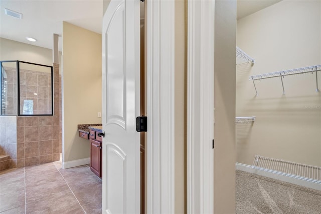 6527 Eagle Ridge Way, Lakeland, FL 33813 - full bathroom with a tile shower, a walk in closet, vanity, recessed lighting, and tile patterned flooring