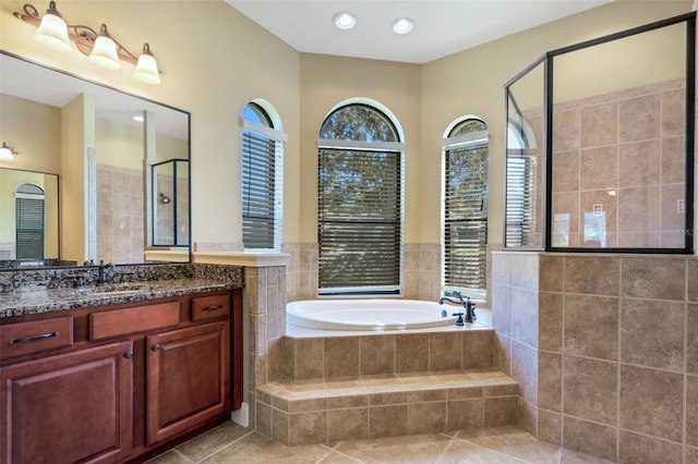 6527 Eagle Ridge Way, Lakeland, FL 33813 - bathroom featuring a garden tub, vanity, tile patterned floors, and a tile shower