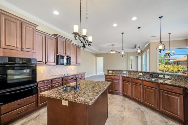 6527 Eagle Ridge Way, Lakeland, FL 33813 - kitchen with black appliances, a warming drawer, crown molding, tasteful backsplash, and a chandelier