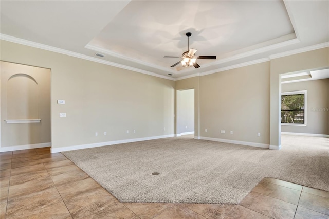 6527 Eagle Ridge Way, Lakeland, FL 33813 - unfurnished room with a tray ceiling, ceiling fan, ornamental molding, light tile patterned floors, and light carpet