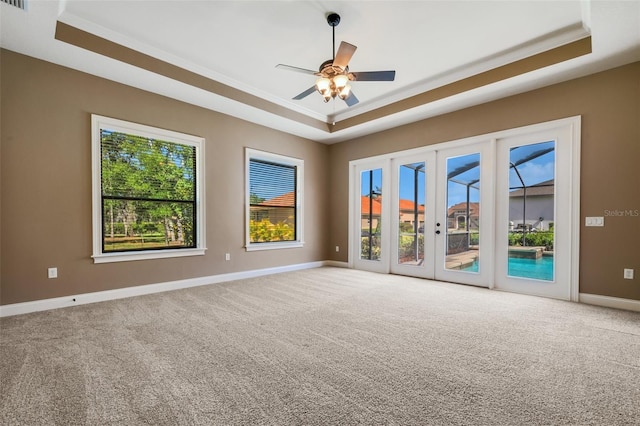 6527 Eagle Ridge Way, Lakeland, FL 33813 - unfurnished room featuring a tray ceiling, carpet flooring, a ceiling fan, and crown molding