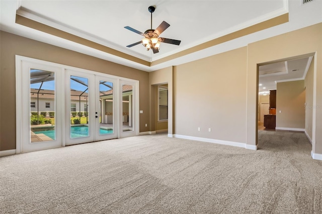 6527 Eagle Ridge Way, Lakeland, FL 33813 - carpeted spare room featuring a raised ceiling, ceiling fan, french doors, and crown molding