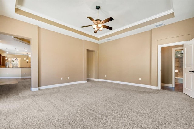 6527 Eagle Ridge Way, Lakeland, FL 33813 - carpeted spare room featuring a tray ceiling, ceiling fan, and crown molding