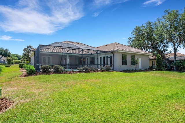 6527 Eagle Ridge Way, Lakeland, FL 33813 - rear view of property featuring a yard, stucco siding, and a tiled roof