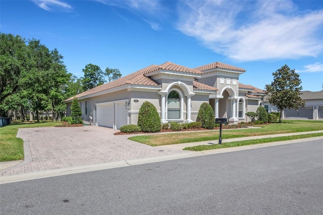 6527 Eagle Ridge Way, Lakeland, FL 33813 - mediterranean / spanish-style home with a garage, a tile roof, stucco siding, and decorative driveway