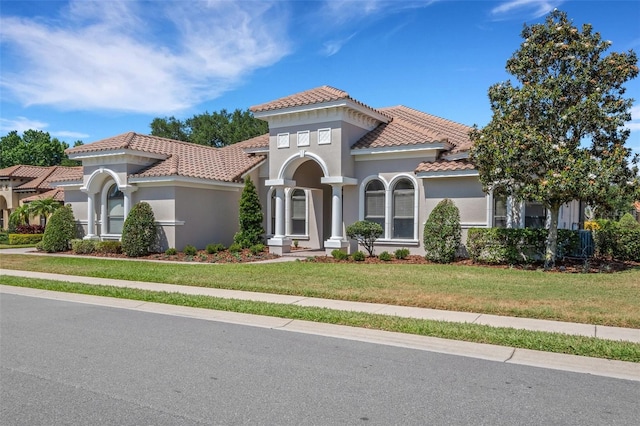 6527 Eagle Ridge Way, Lakeland, FL 33813 - mediterranean / spanish home with a tile roof, a front lawn, and stucco siding