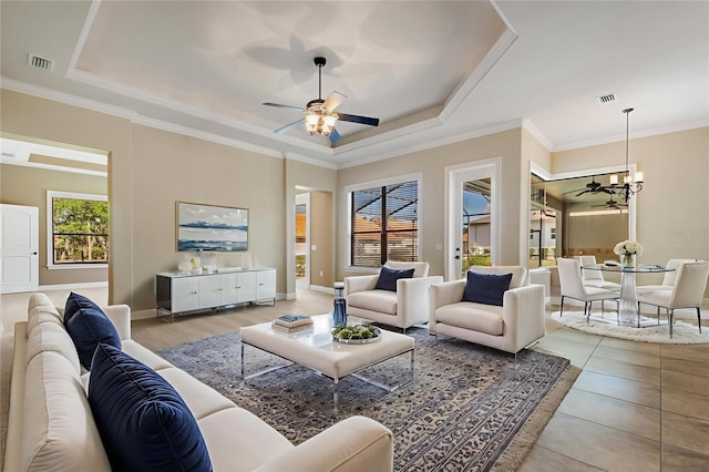 6527 Eagle Ridge Way, Lakeland, FL 33813 - living area featuring ceiling fan, a tray ceiling, a chandelier, and crown molding
