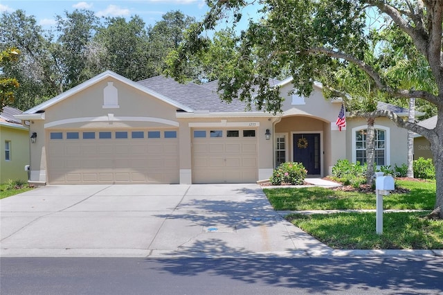 1233 Emerald Hill Way, Valrico, FL 33594 - view of front facade with stucco siding, an attached garage, concrete driveway, and a shingled roof