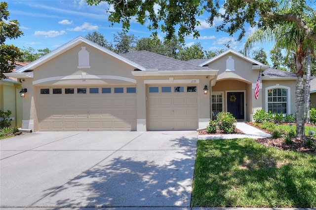1233 Emerald Hill Way, Valrico, FL 33594 - view of front of home featuring stucco siding, an attached garage, concrete driveway, and a shingled roof