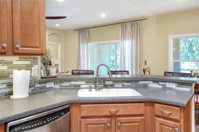 1233 Emerald Hill Way, Valrico, FL 33594 - kitchen featuring stainless steel dishwasher, a sink, decorative backsplash, dark countertops, and recessed lighting