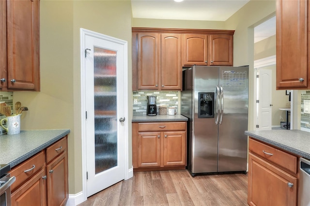 1233 Emerald Hill Way, Valrico, FL 33594 - kitchen featuring stainless steel fridge, backsplash, light wood finished floors, and brown cabinetry