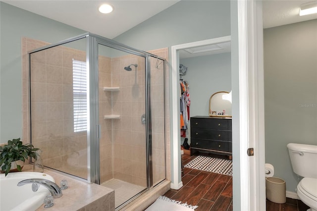 1233 Emerald Hill Way, Valrico, FL 33594 - bathroom featuring a shower stall, toilet, a spacious closet, a bath, and wood finish floors