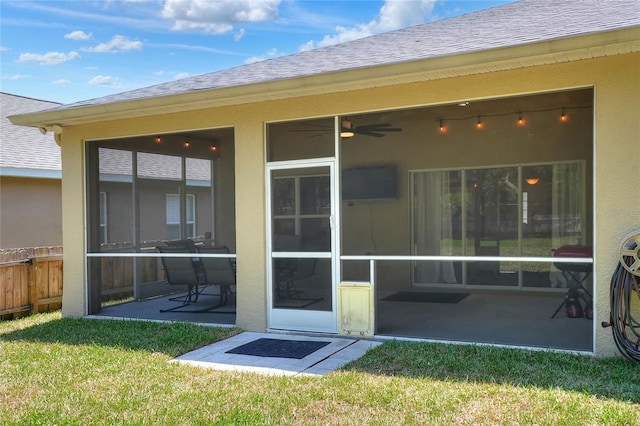 1233 Emerald Hill Way, Valrico, FL 33594 - rear view of property with a sunroom, a lawn, and stucco siding