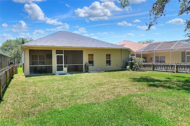 1233 Emerald Hill Way, Valrico, FL 33594 - rear view of property featuring central air condition unit, stucco siding, and a sunroom