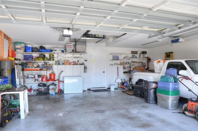 1233 Emerald Hill Way, Valrico, FL 33594 - garage with a workshop area and a garage door opener