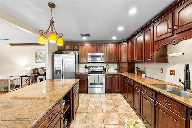 2810 Gary Ln, Lakeland, FL 33812 - kitchen with appliances with stainless steel finishes, a sink, hanging light fixtures, light stone counters, and recessed lighting