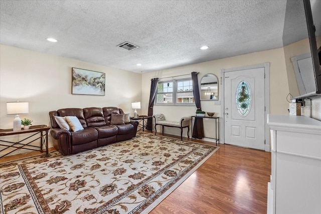 2810 Gary Ln, Lakeland, FL 33812 - living room with a textured ceiling, light wood-type flooring, and recessed lighting