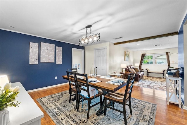 2810 Gary Ln, Lakeland, FL 33812 - dining room with wood finished floors, baseboards, ornamental molding, and beamed ceiling
