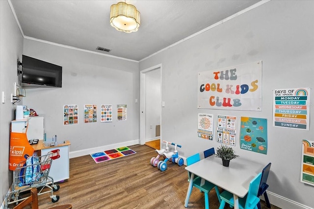 2810 Gary Ln, Lakeland, FL 33812 - playroom with ornamental molding, wood finished floors, and baseboards