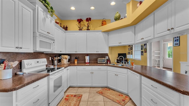 2025 Viewpoint Landings Rd, Lakeland, FL 33810 - kitchen with white appliances, dark countertops, a sink, light tile patterned flooring, and tasteful backsplash