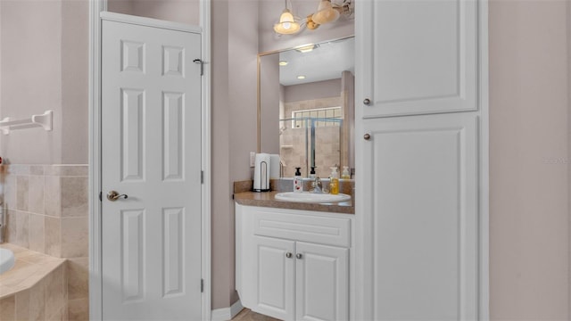 2025 Viewpoint Landings Rd, Lakeland, FL 33810 - bathroom featuring a stall shower, vanity, and a relaxing tiled tub