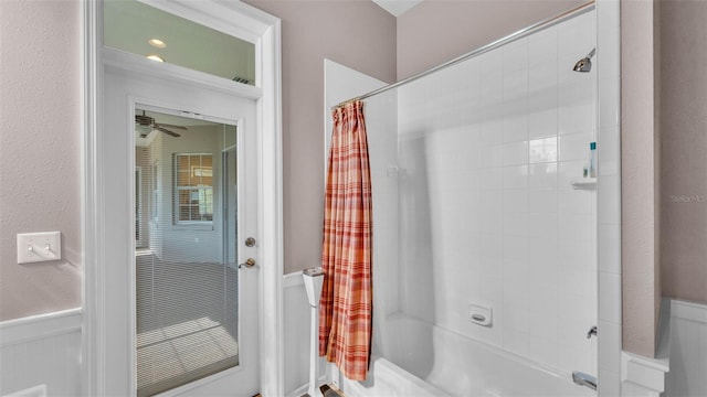 2025 Viewpoint Landings Rd, Lakeland, FL 33810 - bathroom featuring shower / tub combo with curtain and wainscoting