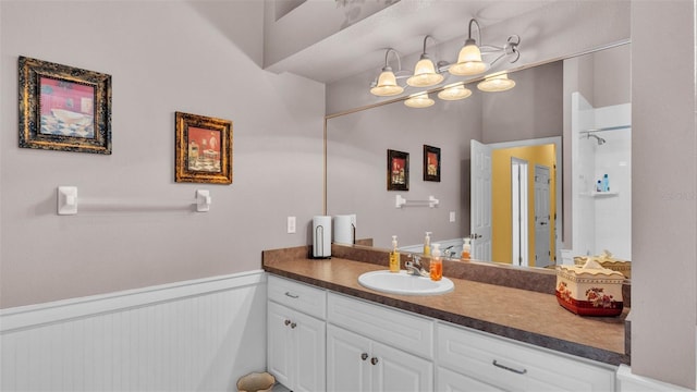 2025 Viewpoint Landings Rd, Lakeland, FL 33810 - full bath with vanity, a wainscoted wall, and a shower