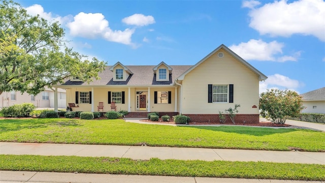 2025 Viewpoint Landings Rd, Lakeland, FL 33810 - cape cod home with covered porch and a front lawn
