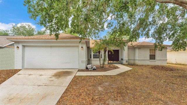 7311 Briarbay Loop, Lakeland, FL 33810 - ranch-style house featuring a garage, stucco siding, and concrete driveway