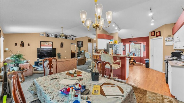 7311 Briarbay Loop, Lakeland, FL 33810 - dining area with lofted ceiling, light wood-style floors, ceiling fan, track lighting, and a chandelier
