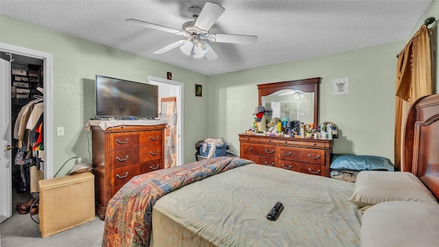 7311 Briarbay Loop, Lakeland, FL 33810 - bedroom with carpet flooring, a spacious closet, a closet, a textured ceiling, and a ceiling fan