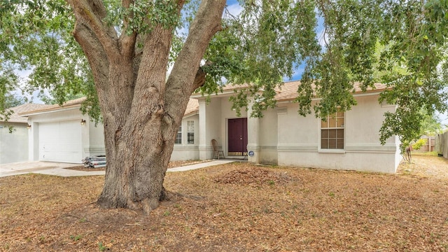 7311 Briarbay Loop, Lakeland, FL 33810 - view of front facade with an attached garage, stucco siding, and concrete driveway