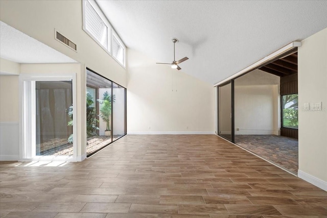 107 Seville Ct N, Plant City, FL 33566 - spare room with ceiling fan, wood finished floors, high vaulted ceiling, and baseboards