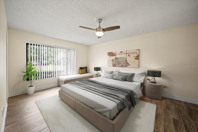 107 Seville Ct N, Plant City, FL 33566 - bedroom with wood finished floors, baseboards, a textured ceiling, and a ceiling fan