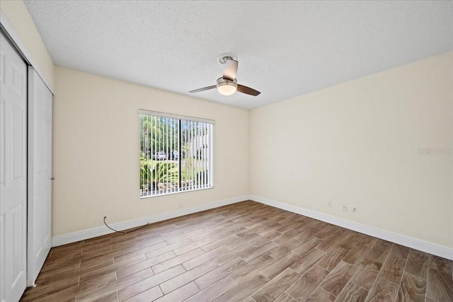107 Seville Ct N, Plant City, FL 33566 - unfurnished bedroom with wood finished floors, a closet, baseboards, ceiling fan, and a textured ceiling