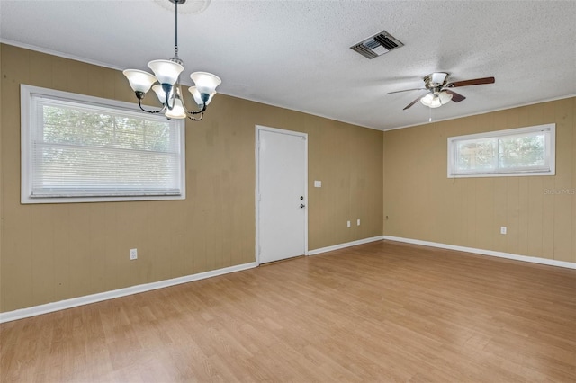 3427 S Polk Ave, Lakeland, FL 33803 - spare room featuring light wood finished floors, a chandelier, ceiling fan, baseboards, and a textured ceiling