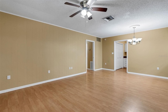3427 S Polk Ave, Lakeland, FL 33803 - unfurnished room featuring light wood finished floors, a chandelier, ceiling fan, baseboards, and a textured ceiling
