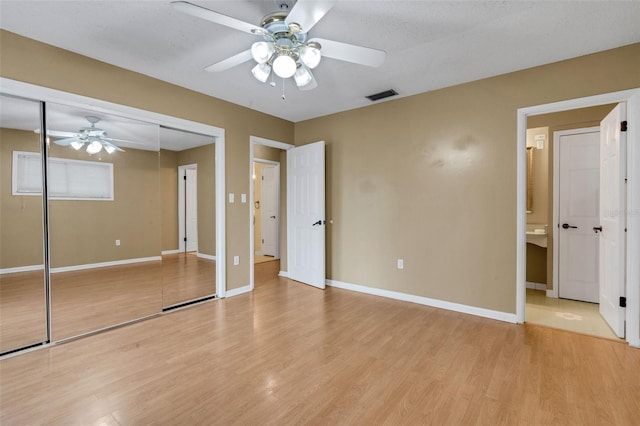 3427 S Polk Ave, Lakeland, FL 33803 - unfurnished bedroom featuring light wood-style floors, baseboards, a closet, and a ceiling fan