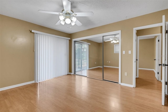 3427 S Polk Ave, Lakeland, FL 33803 - unfurnished bedroom featuring light wood-type flooring, a textured ceiling, baseboards, ceiling fan, and a closet