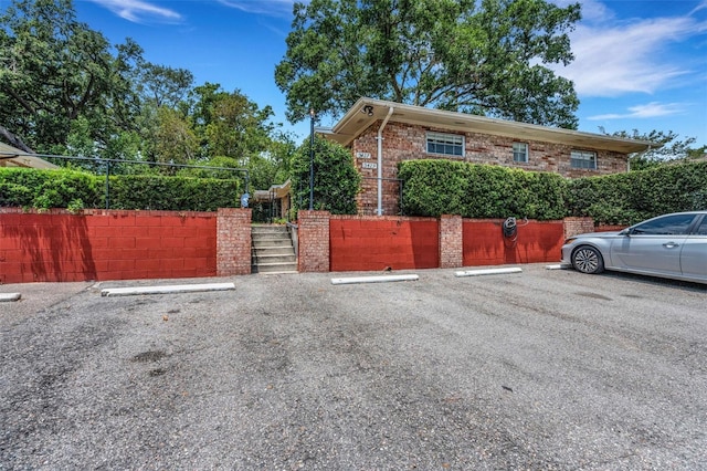 3427 S Polk Ave, Lakeland, FL 33803 - view of side of property with uncovered parking, stairway, and brick siding
