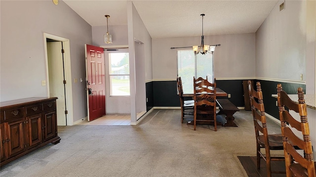 dining area with a chandelier, plenty of natural light, light colored carpet, and baseboards