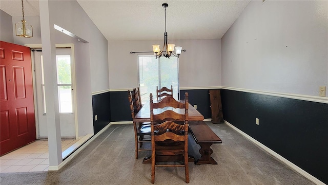 dining room with a chandelier, carpet, baseboards, and a textured ceiling