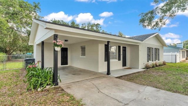 3829 Abbott Ln, Lakeland, FL 33810 - view of front of property with concrete driveway, an attached carport, central air condition unit, and a gate