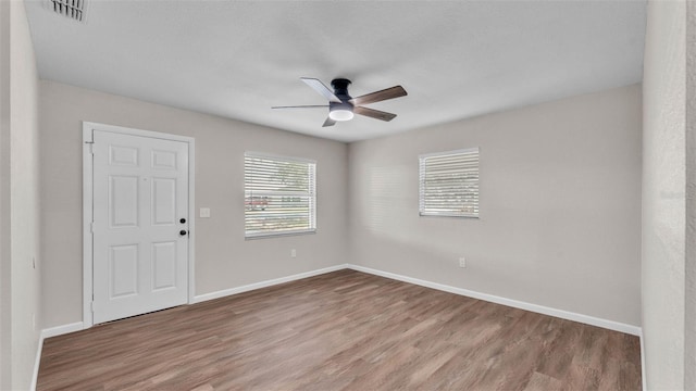 3829 Abbott Ln, Lakeland, FL 33810 - unfurnished room featuring a ceiling fan, wood finished floors, and baseboards