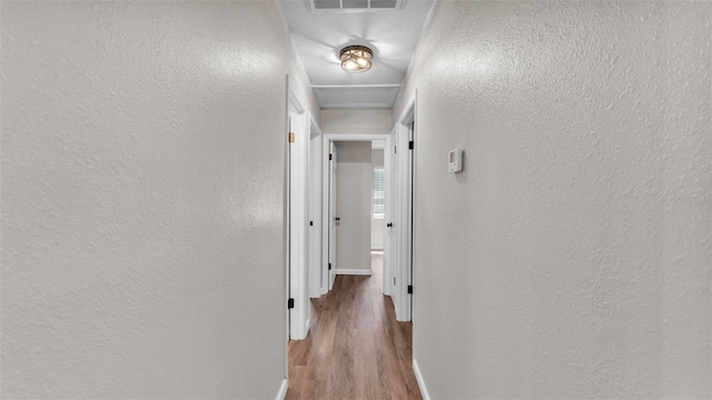 3829 Abbott Ln, Lakeland, FL 33810 - corridor featuring a textured wall, baseboards, and wood finished floors
