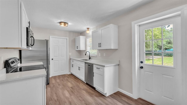 3829 Abbott Ln, Lakeland, FL 33810 - kitchen featuring a sink, appliances with stainless steel finishes, light countertops, and healthy amount of natural light
